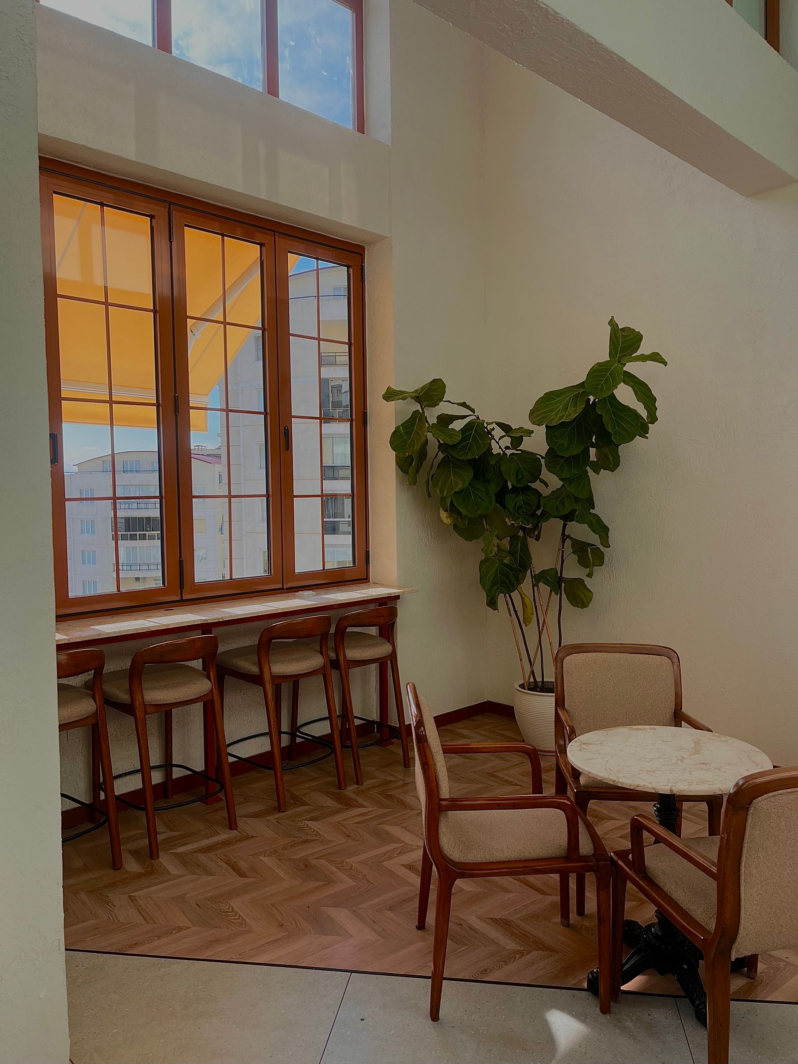 Warm Northern New Jersey business interior with tables, natural light, and plants